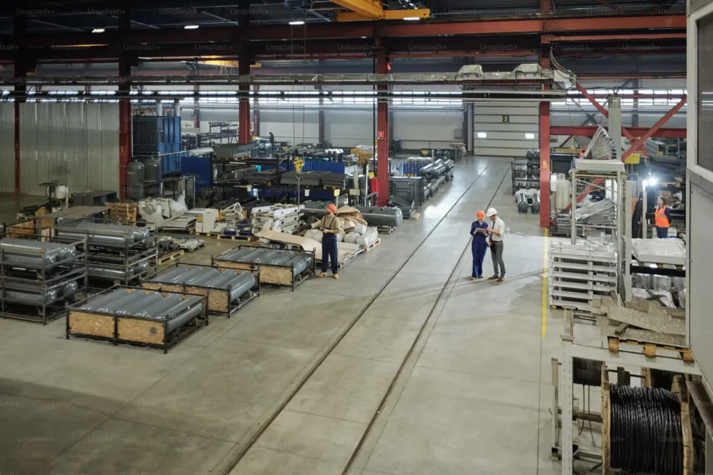 Supervisors walking the floor of a large manufacturing plant