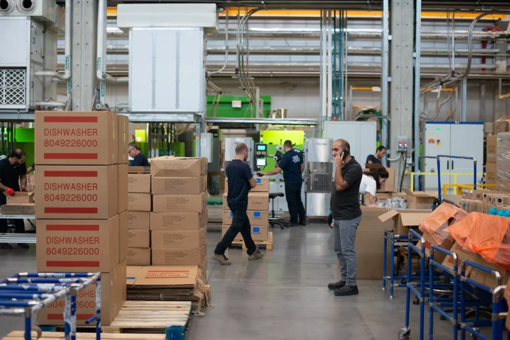 Warehouse team handling boxed appliances