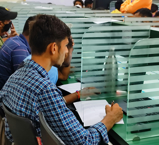 Customers filling in forms at a bank branch
