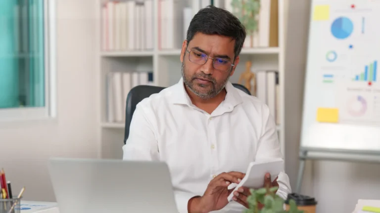 Indian commercial support executive working on accounts at a laptop