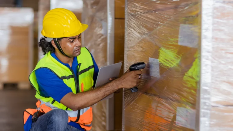 Indian warehouse associate scanning parcels in a fulfilment centre