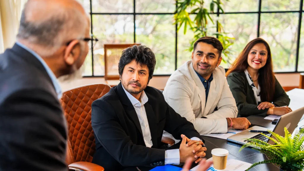 Senior leader meeting a team of professionals around a conference table