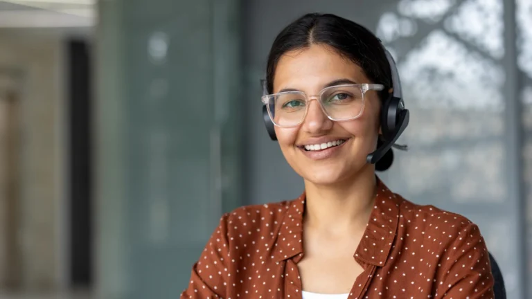 Indian tele-sales agent with a headset in a modern office