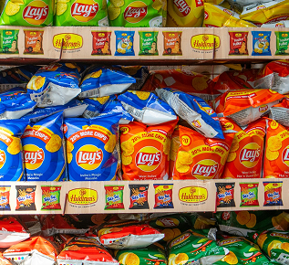 Supermarket shelves stocked with snack packets