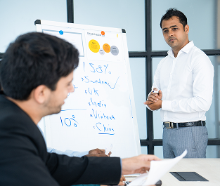 Consultant presenting attrition figures on a whiteboard