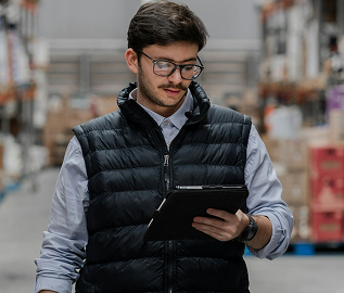 Warehouse supervisor checking stock on a tablet